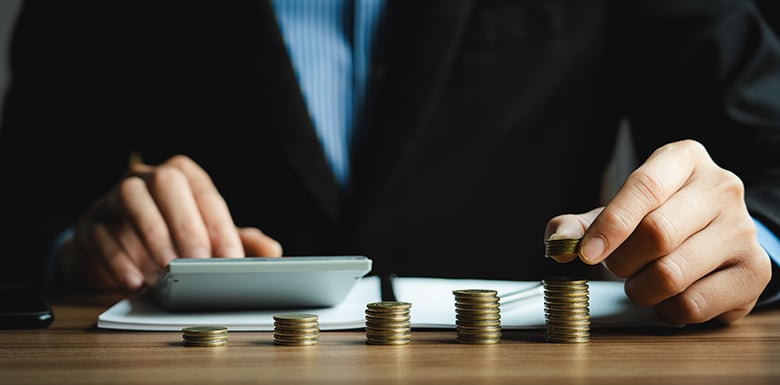 Man counting stacks of coins