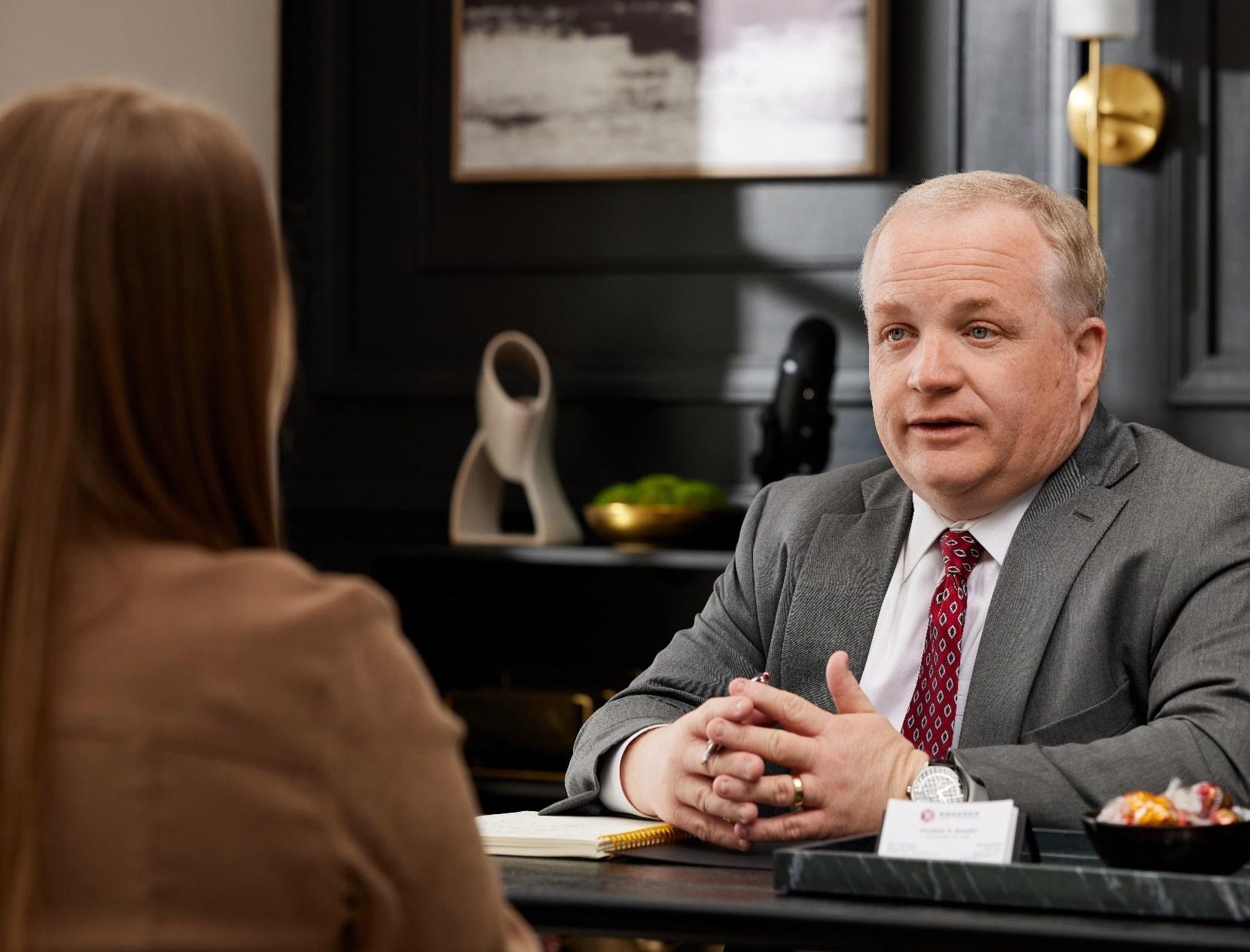 Attorney Jonathan Breeden speaking to female client