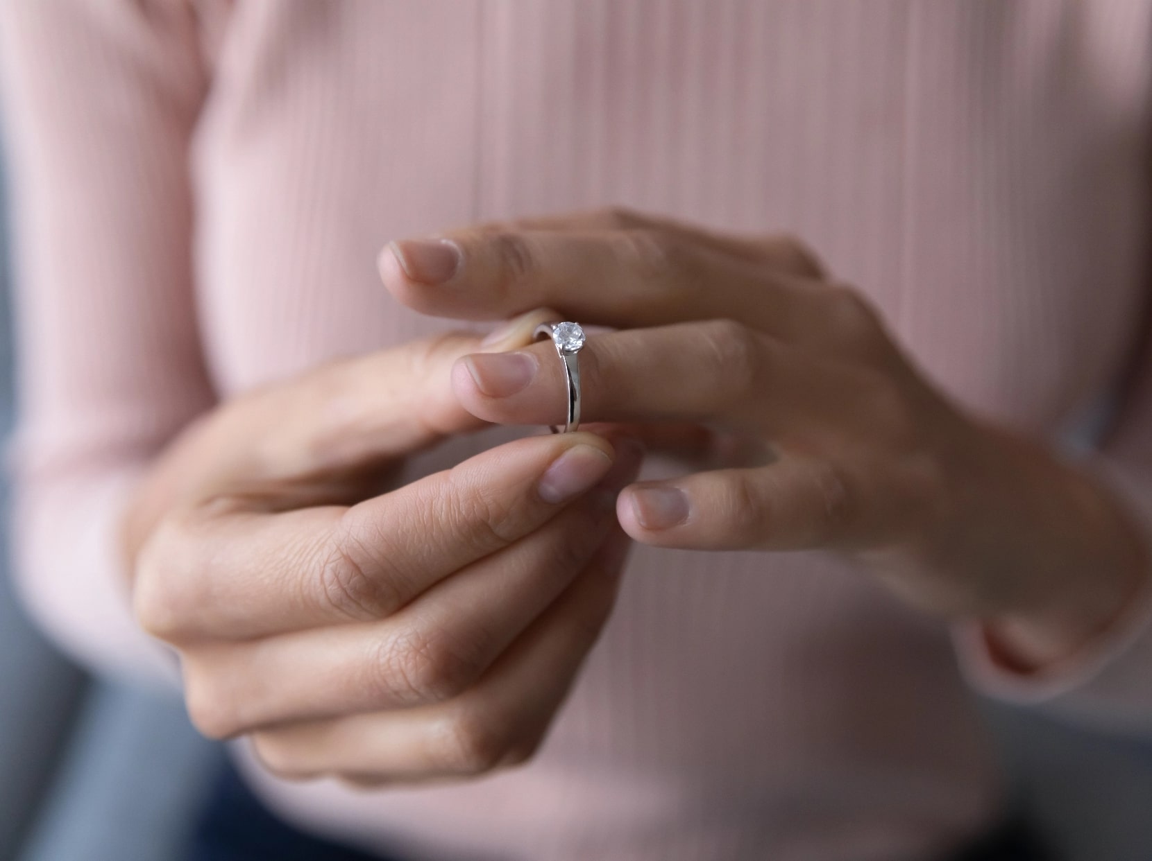 Woman removing wedding ring