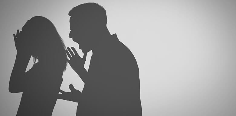 Silhouette of man yelling at woman