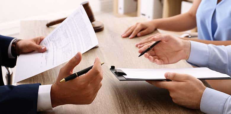 People discussing paperwork at a table