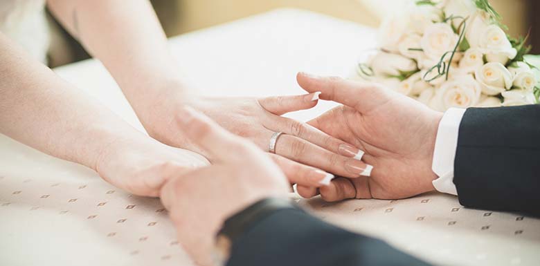 Bride and groom holding hands on wedding day