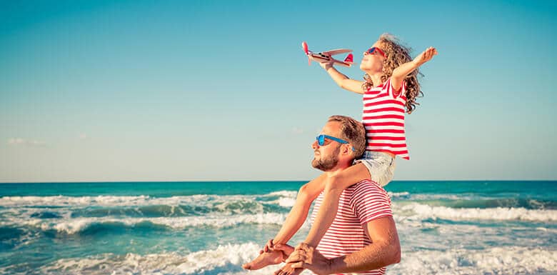 Dad and daughter at the beach on a sunny day