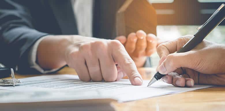 Attorney pointing to where to sign paperwork