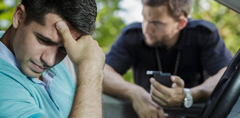 Man looking upset while getting a Breathalyzer test