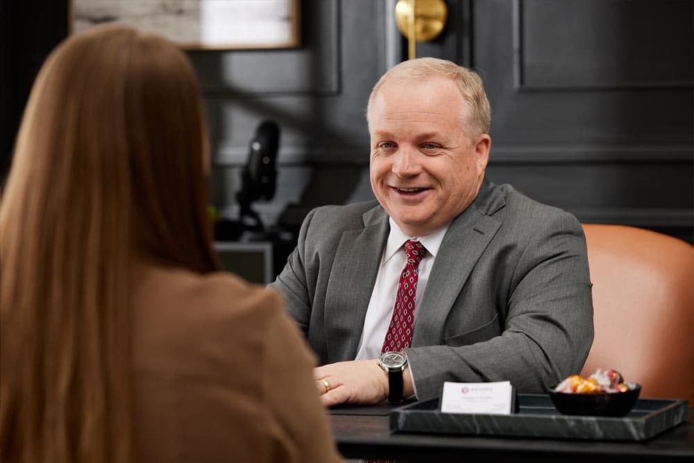 Attorney Jonathan Breeden sitting at desk across from client