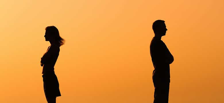 Man and woman silhouettes facing away from each other