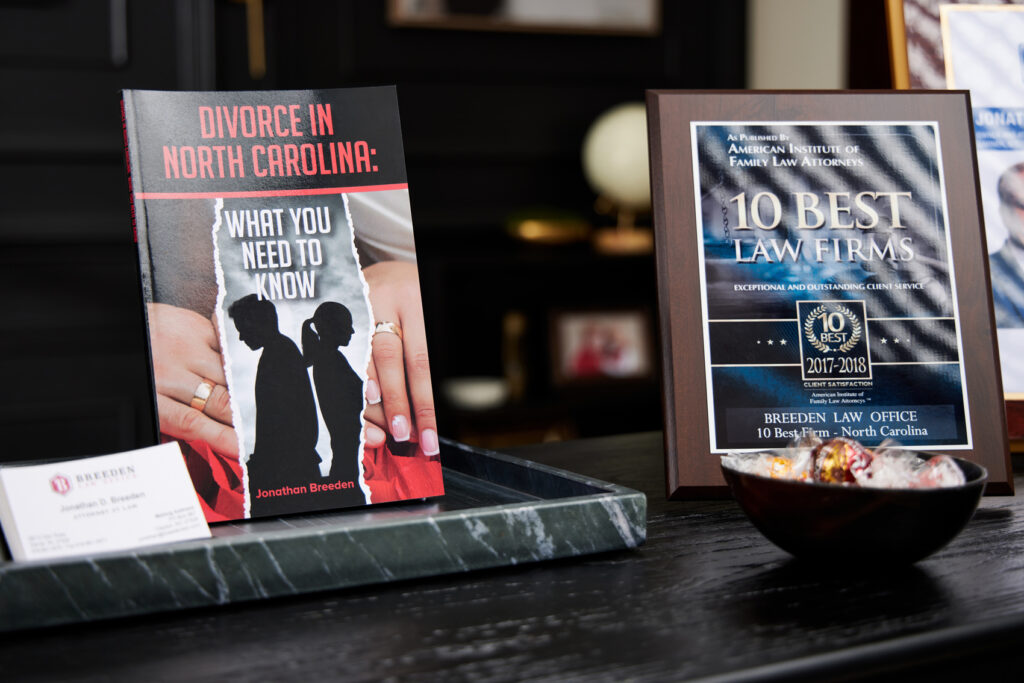 Jonathan Breeden's book sitting on desk next to awards and business cards