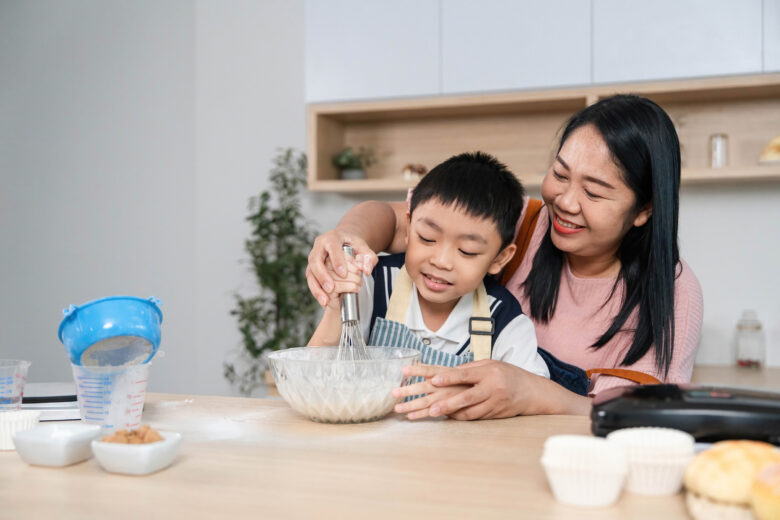 A mother mixes ingredients with her child after working with her attorney to enforce a child support payment.